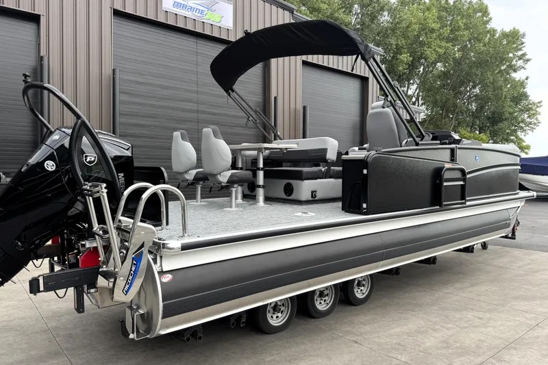 Slide: The Image of 2026 Premier 230 SOLARIS RS pontoon boat with modern design and seating, parked outdoors. - 7