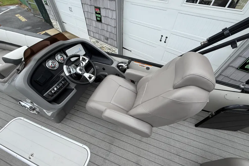 Slide: The Image of 2022 Avalon 2585 Catalina VRB boat cockpit with steering wheel and plush captain's chair. - 21