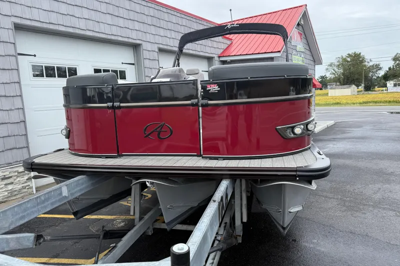Slide: The Image of 2022 Avalon 2585 Catalina VRB Tri Toon boat on trailer, red and black design. - 5