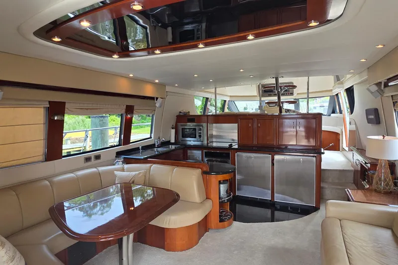 Slide: The Image of Luxurious interior of a 2006 Carver 56 Voyager yacht with modern kitchen and seating area. - 12