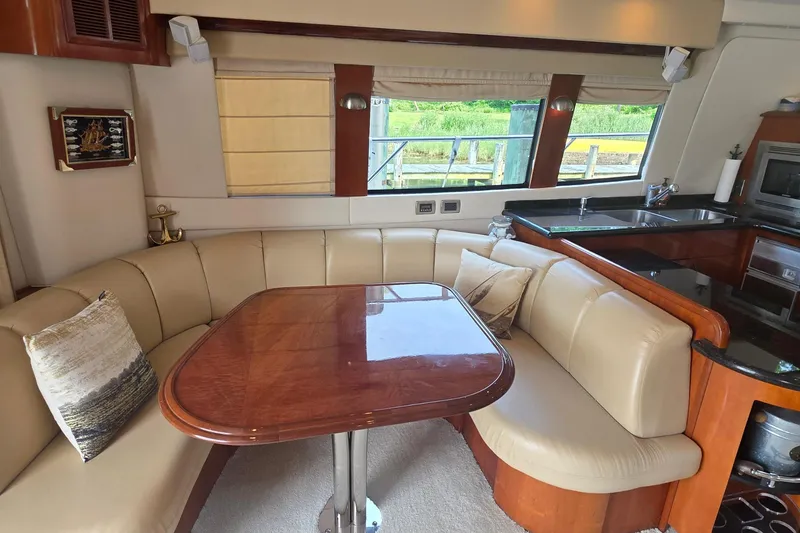 Slide: The Image of Luxurious interior of 2006 Carver 56 Voyager yacht with elegant dining area. - 13