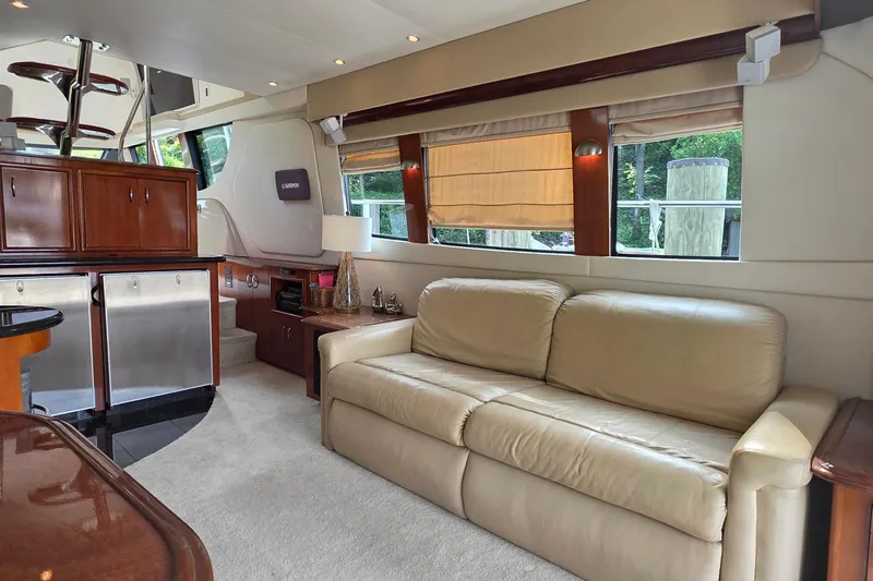 Slide: The Image of Luxurious interior of 2006 Carver 56 Voyager yacht with beige sofa and wooden accents. - 14