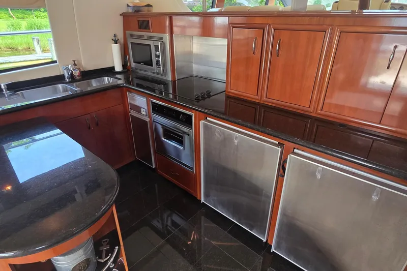 Slide: The Image of Luxurious kitchen in 2006 Carver 56 Voyager yacht with sleek wood cabinetry and modern appliances. - 15