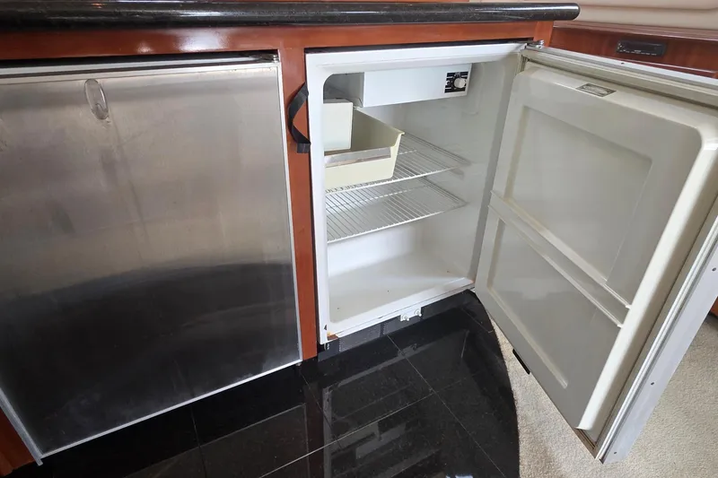 Slide: The Image of Open refrigerator in 2006 Carver 56 Voyager yacht kitchen, featuring stainless steel finish. - 16