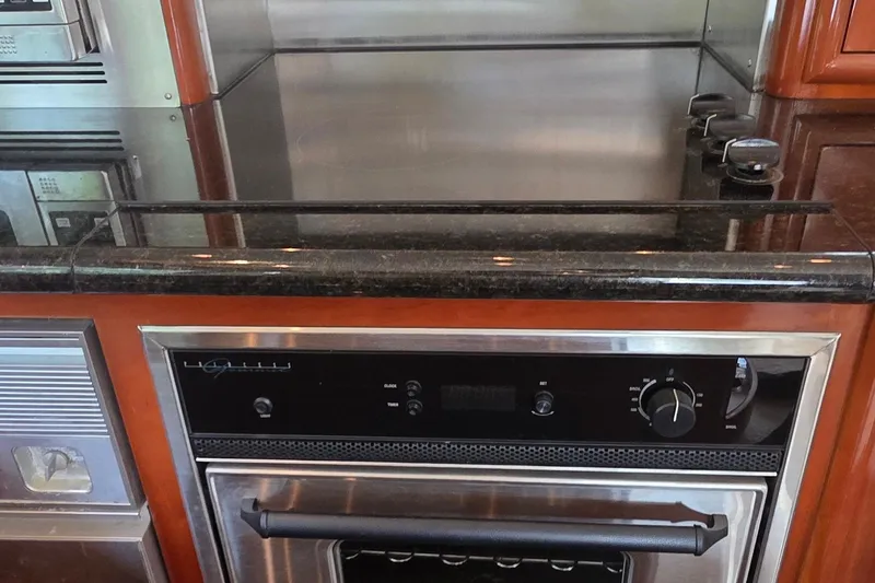 Slide: The Image of 2006 Carver 56 Voyager kitchen with modern stove and oven setup. - 18
