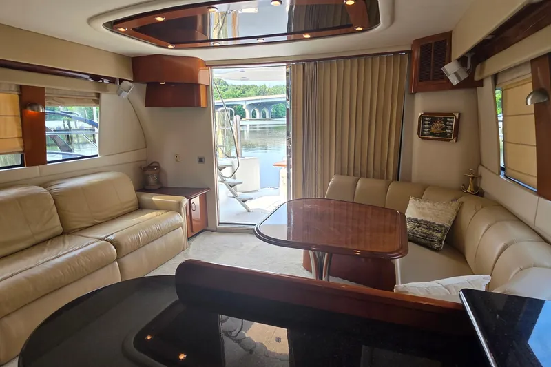 Slide: The Image of Interior of 2006 Carver 56 Voyager yacht with luxurious seating and dining area. - 22