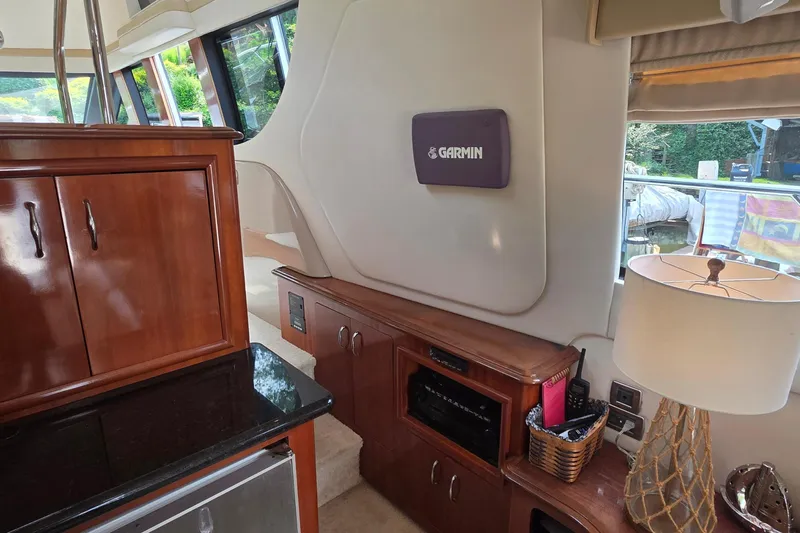 Slide: The Image of Interior of 2006 Carver 56 Voyager yacht with Garmin navigation system and elegant wood cabinetry. - 23