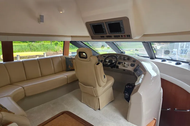 Slide: The Image of Interior of 2006 Carver 56 Voyager yacht with beige seating and modern helm. - 24