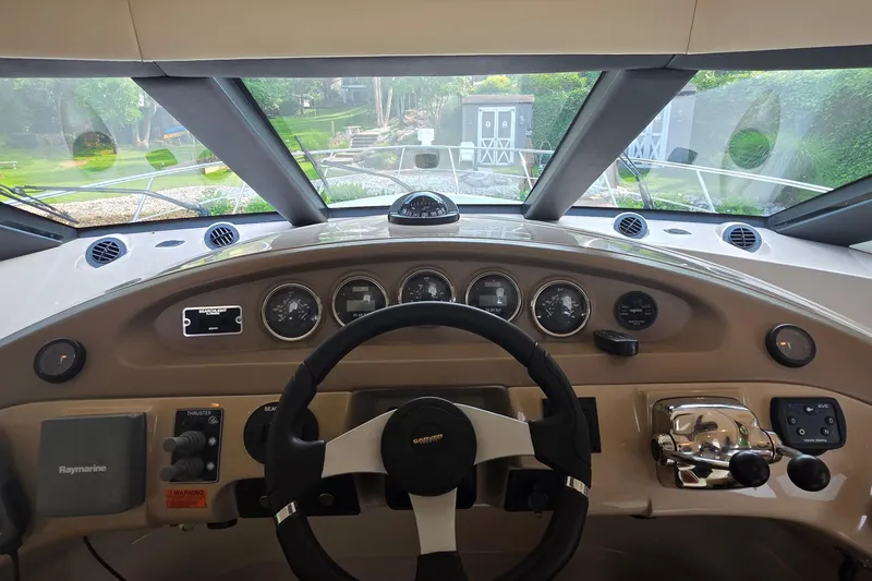 Slide: The Image of 2006 Carver 56 Voyager helm with steering wheel, gauges, and navigation controls. - 26