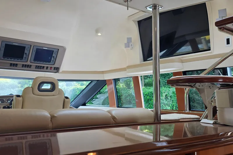 Slide: The Image of Interior of 2006 Carver 56 Voyager yacht with luxurious seating and navigation displays. - 29