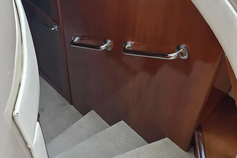 Slide: The Image of Staircase with wooden paneling and chrome handles on a 2006 Carver 56 Voyager yacht. - 30