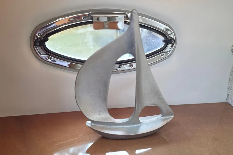 Slide: The Image of Decorative sailboat sculpture near a porthole on a 2006 Carver 56 Voyager yacht. - 31