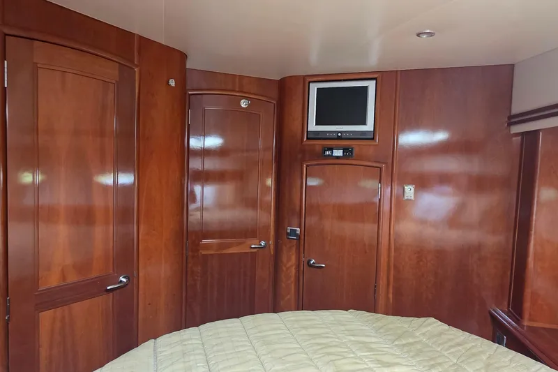 Slide: The Image of Interior of 2006 Carver 56 Voyager with wood paneling and mounted TV. - 34