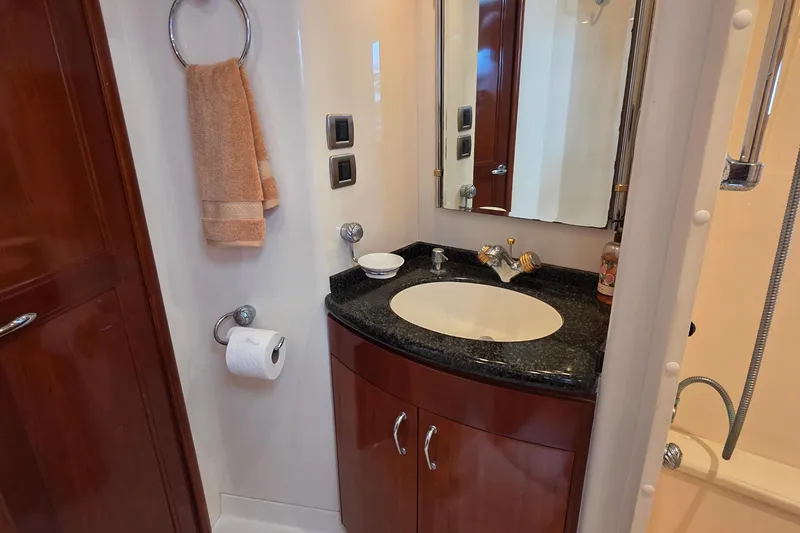 Slide: The Image of Luxurious bathroom in 2006 Carver 56 Voyager yacht with elegant fixtures and wood cabinetry. - 36
