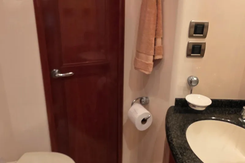 Slide: The Image of Bathroom interior of 2006 Carver 56 Voyager yacht with sink and wooden door. - 37