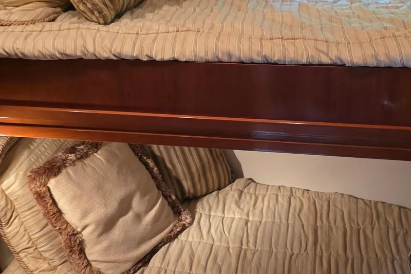 Slide: The Image of Interior of 2006 Carver 56 Voyager with cozy bunk beds and striped bedding. - 38