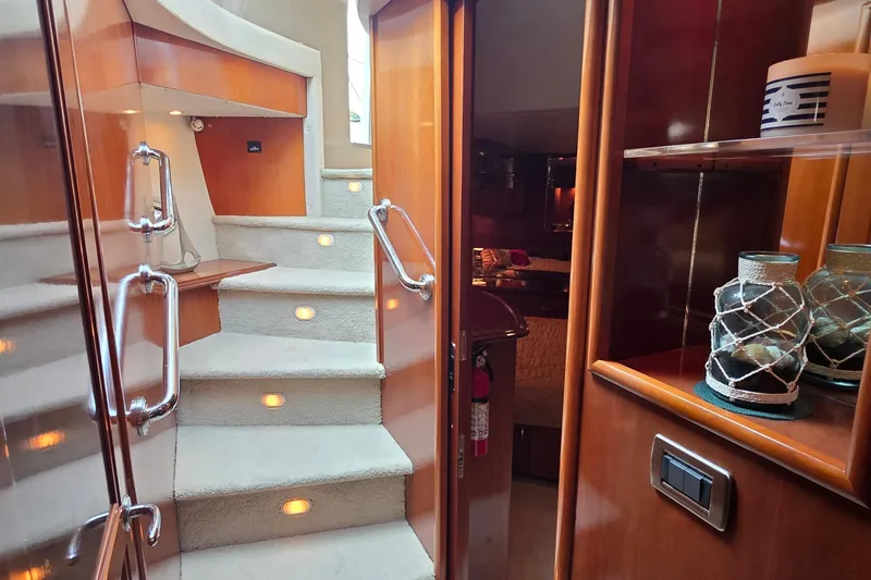 Slide: The Image of Interior of 2006 Carver 56 Voyager yacht with carpeted stairs and wooden cabinetry. - 41