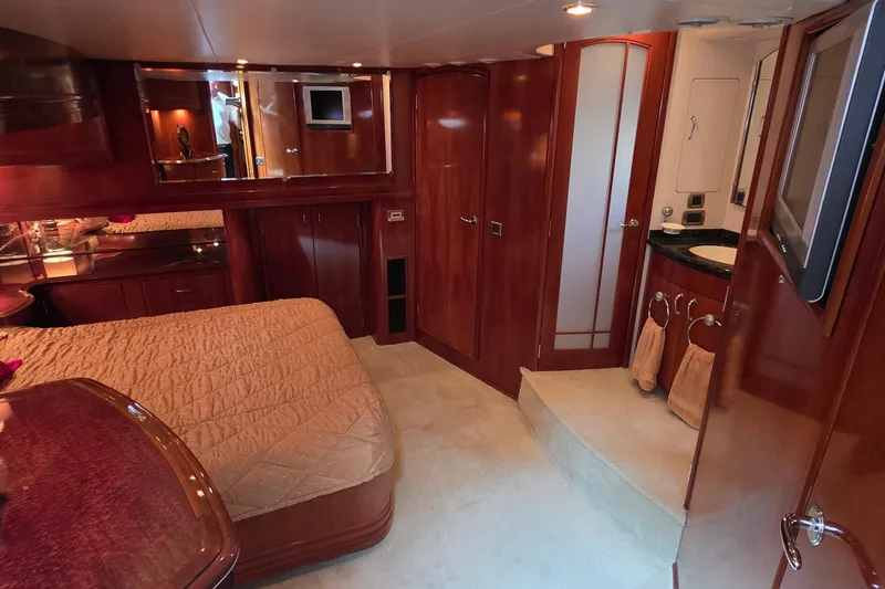 Slide: The Image of Luxurious interior of 2006 Carver 56 Voyager yacht with wood finishes and cozy bedroom. - 43
