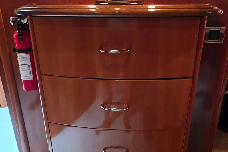 Slide: The Image of Wooden cabinet with drawers and a fire extinguisher on a 2006 Carver 56 Voyager yacht. - 46