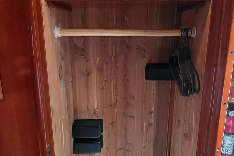 Slide: The Image of Wooden closet interior with hangers in a 2006 Carver 56 Voyager yacht. - 47