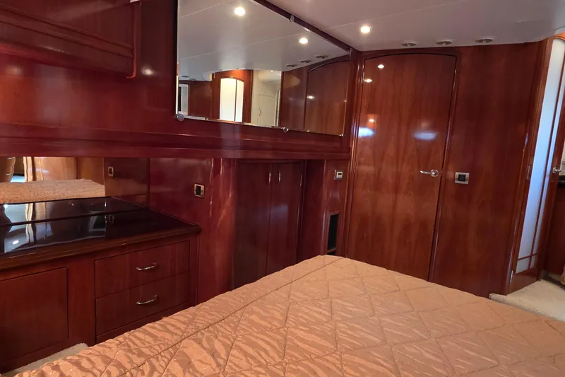 Slide: The Image of Luxurious 2006 Carver 56 Voyager yacht interior with elegant wood finish and cozy bedding. - 48