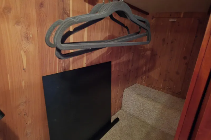 Slide: The Image of Wooden closet interior with hangers, inside a 2006 Carver 56 Voyager yacht. - 51