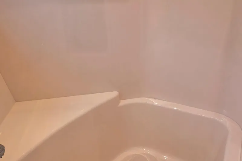 Slide: The Image of Interior of 2006 Carver 56 Voyager shower area with smooth, white surfaces. - 53