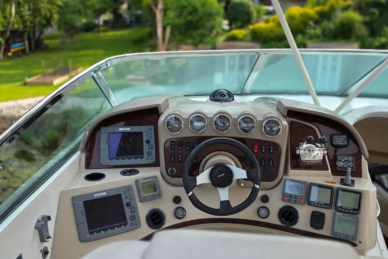 Slide: The Image of Helm of 2006 Carver 56 Voyager yacht with navigation instruments and steering wheel. - 58