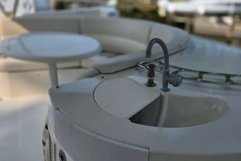 Slide: The Image of 2006 Carver 56 Voyager yacht deck with sink and seating area. - 63