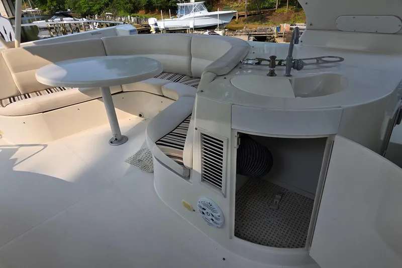 Slide: The Image of 2006 Carver 56 Voyager yacht interior with seating, table, and sink area. - 64