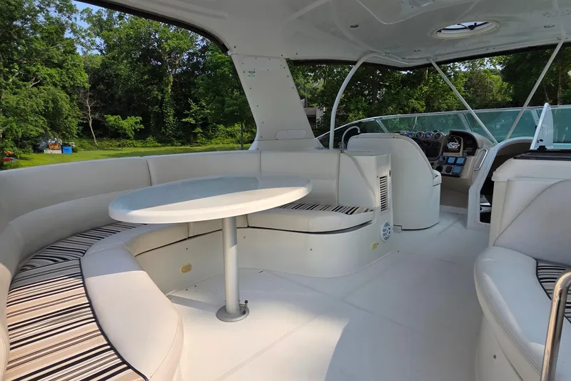 Slide: The Image of 2006 Carver 56 Voyager yacht interior with white seating and round table. - 65