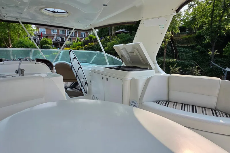Slide: The Image of 2006 Carver 56 Voyager yacht interior with white seating and outdoor grill. - 66