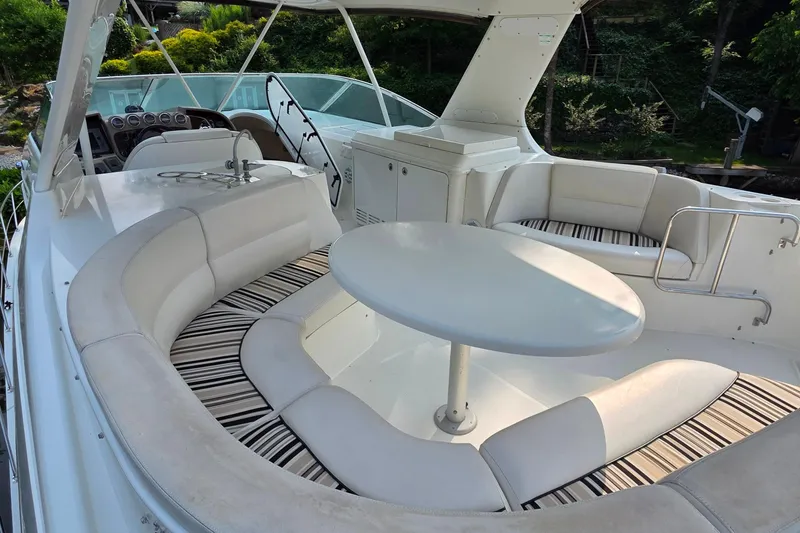 Slide: The Image of 2006 Carver 56 Voyager yacht interior with white seating and round table. - 68