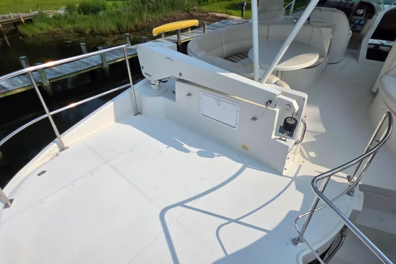 Slide: The Image of 2006 Carver 56 Voyager yacht deck with seating and railing, dockside view. - 69