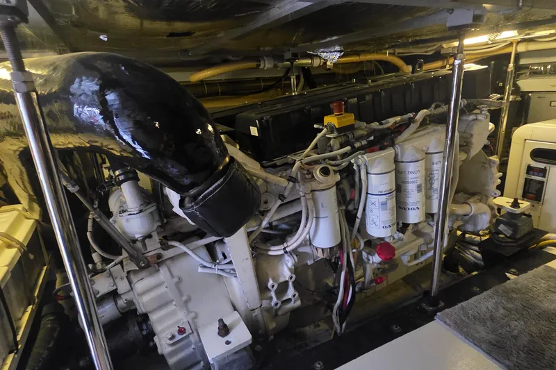 Slide: The Image of Engine room of a 2006 Carver 56 Voyager yacht, showcasing mechanical components. - 73