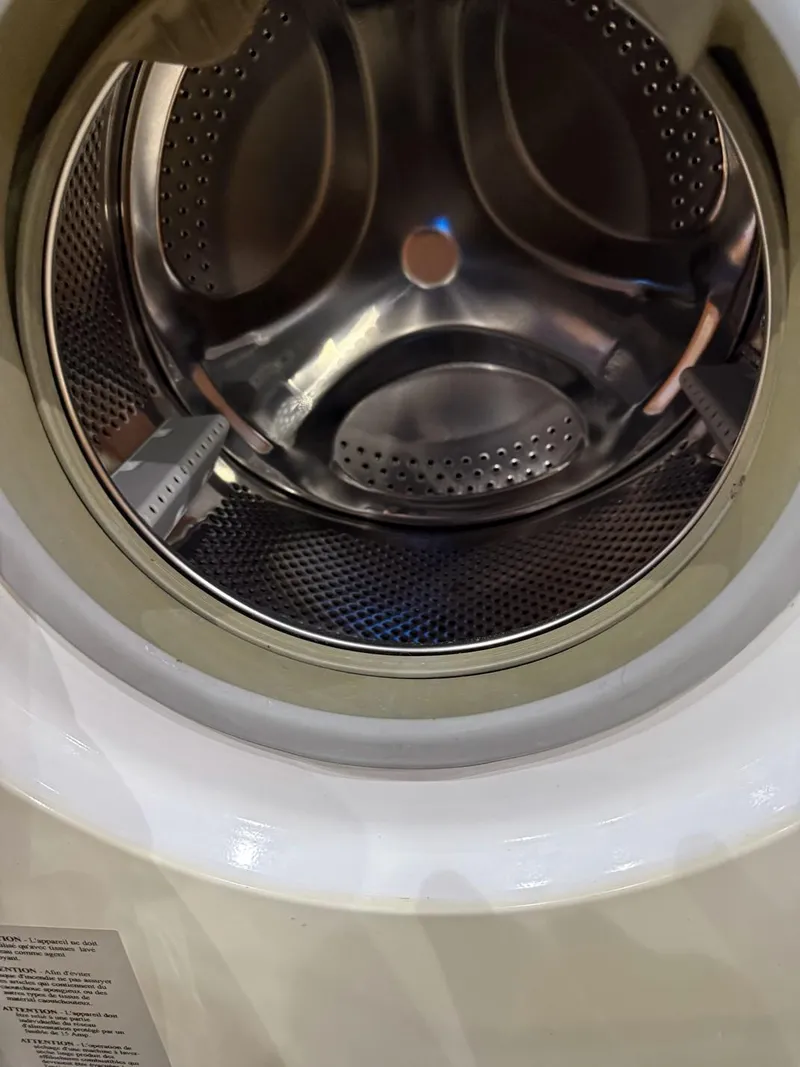 Slide: The Image of Close-up of a washing machine drum, stainless steel interior, front-loading design. - 14