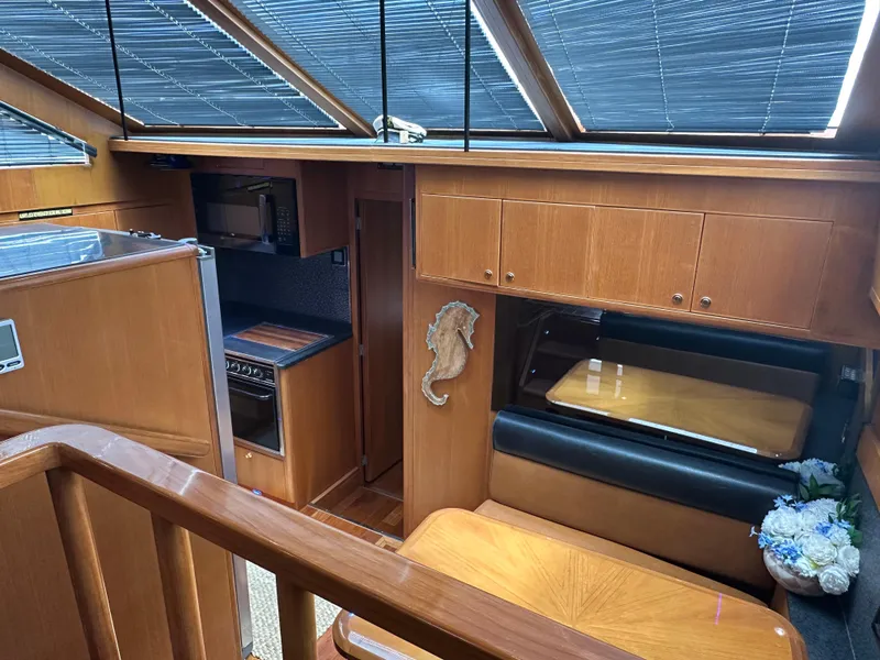 Slide: The Image of 2005 Jefferson Rivanna 50 SDMY yacht interior with wood finish, dining area, and kitchen. - 17