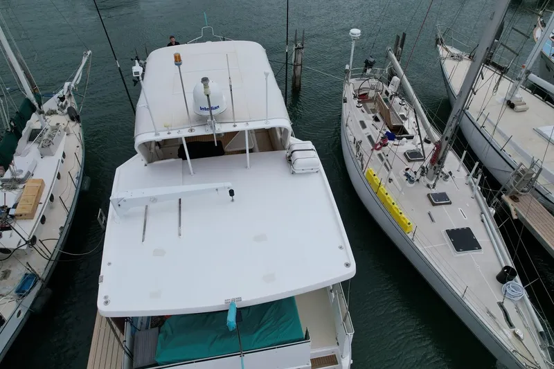 Slide: The Image of 2005 Jefferson Rivanna 50 SDMY yacht docked between sailboats. - 4