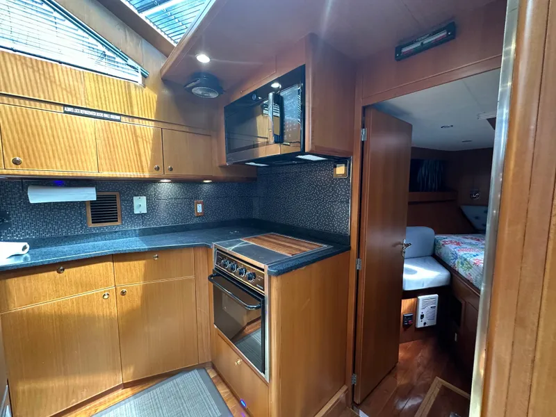 Slide: The Image of 2005 Jefferson Rivanna 50 SDMY yacht interior with modern kitchen and cozy bedroom. - 40