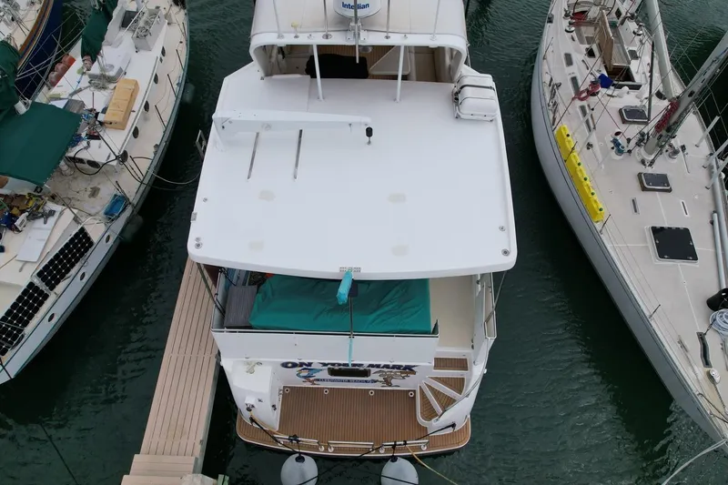 Slide: The Image of 2005 Jefferson Rivanna 50 SDMY yacht docked between two boats, aerial view. - 5