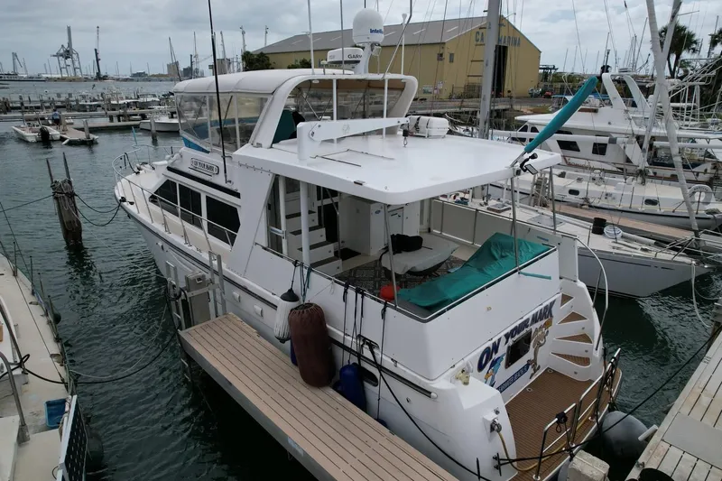 Slide: The Image of 2005 Jefferson Rivanna 50 SDMY yacht docked at marina, surrounded by other boats. - 6