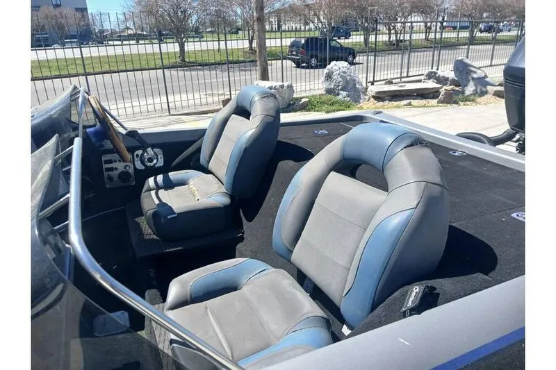 Slide: The Image of 1994 Gambler 21 boat interior with two gray and blue seats, steering wheel, and dashboard. - 8