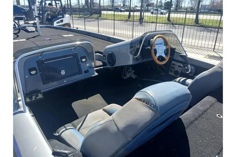 Slide: The Image of Interior of a 1994 Gambler 21 boat with a steering wheel and seating. - 9