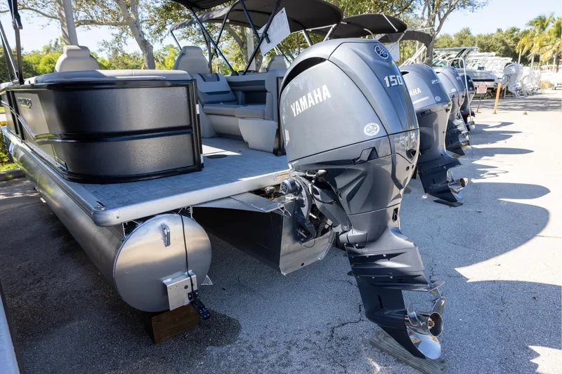 Slide: The Image of 2026 Premier 220 Sunscape RF pontoon boat with Yamaha outboard engines, parked outdoors. - 3