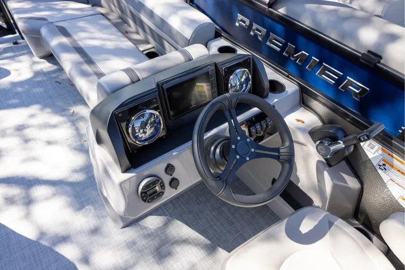 Slide: The Image of 2026 Premier 220 Sunscape RF boat dashboard with steering wheel and controls. - 8