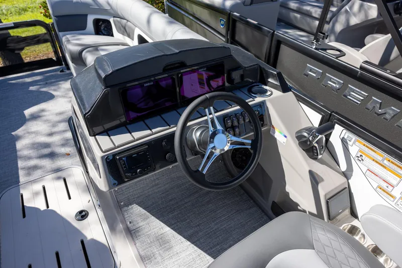 Slide: The Image of 2026 Premier 230 Solaris RF boat dashboard with steering wheel and control panel. - 6