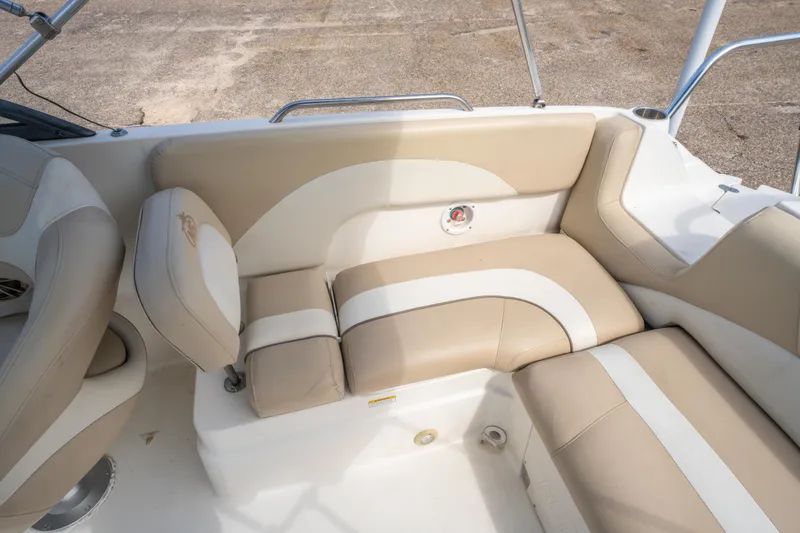 Slide: The Image of 2017 NauticStar 223DC Sport Deck boat interior with beige and white cushioned seating. - 13