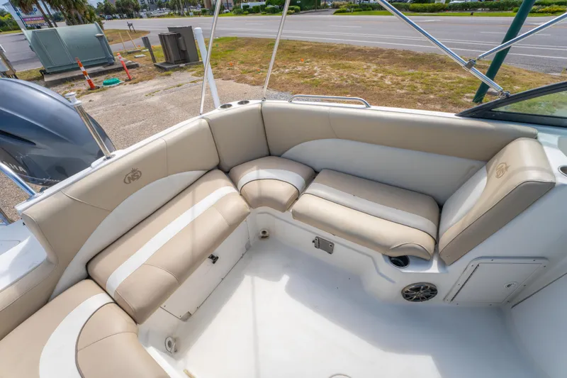 Slide: The Image of 2017 NauticStar 223DC Sport Deck boat with beige seating and spacious deck area. - 14