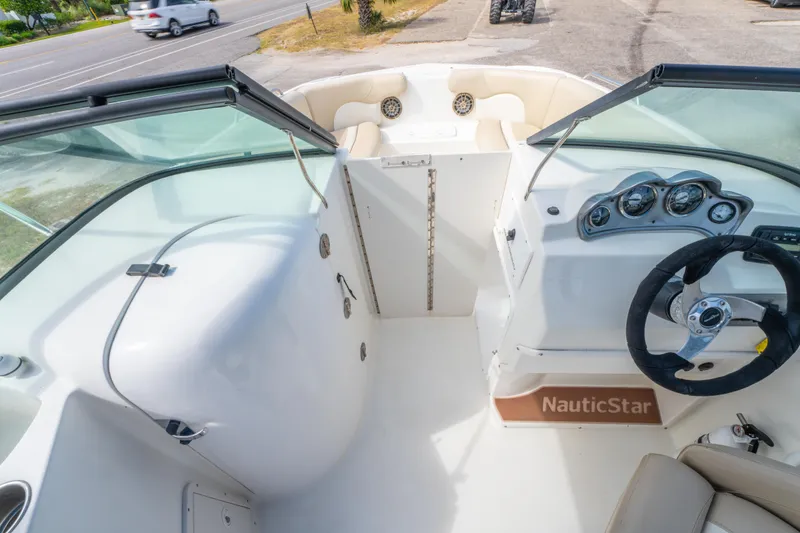 Slide: The Image of 2017 NauticStar 223DC Sport Deck boat interior with steering wheel and dashboard. - 18
