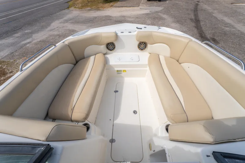 Slide: The Image of 2017 NauticStar 223DC Sport Deck boat interior with beige seating and speakers. - 19